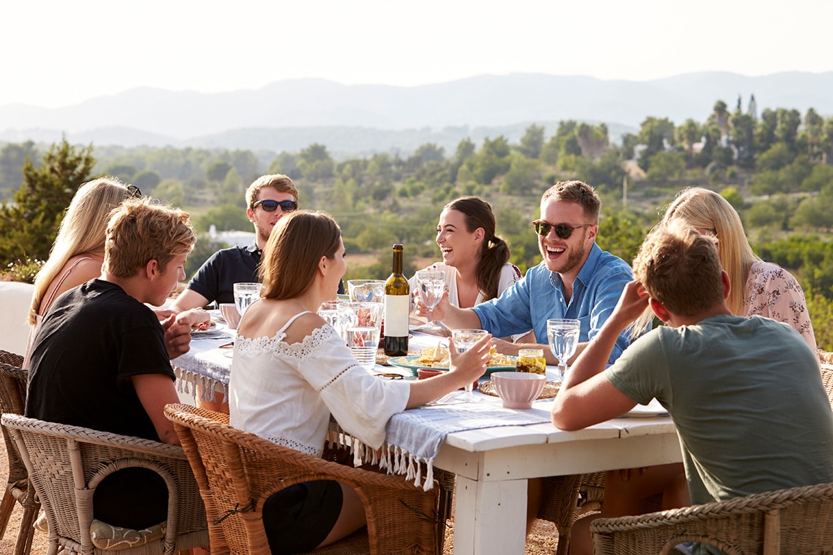group of young friends enjoying outdoor meal on pali retreat
